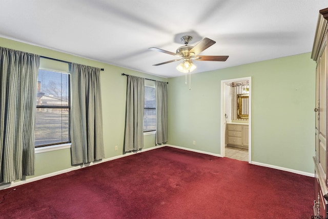 carpeted spare room with a wealth of natural light and ceiling fan