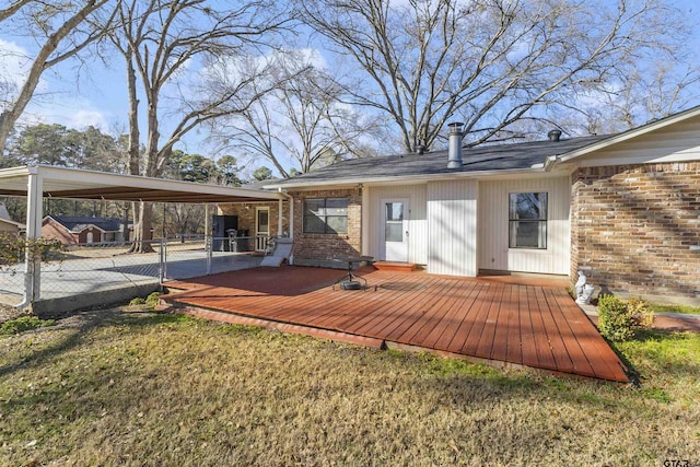 rear view of house with a deck and a lawn