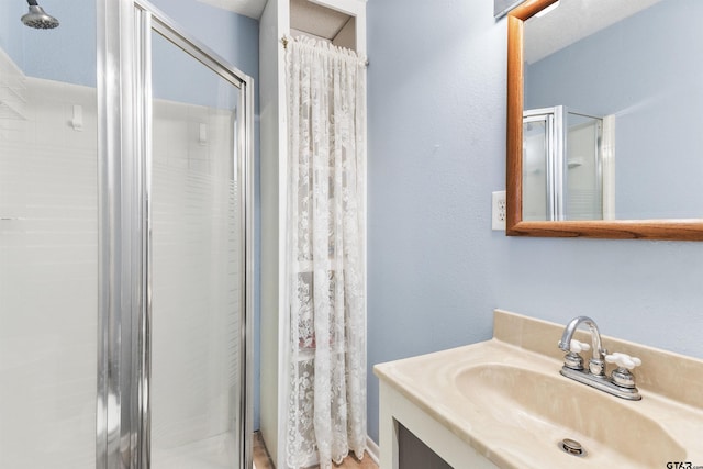 bathroom featuring vanity and walk in shower