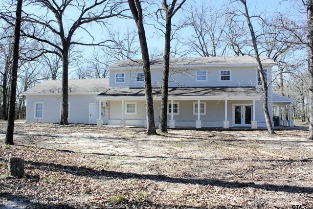 rear view of property with french doors and a porch