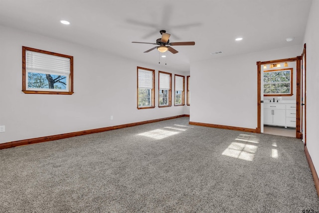 empty room featuring carpet flooring, a ceiling fan, baseboards, visible vents, and recessed lighting