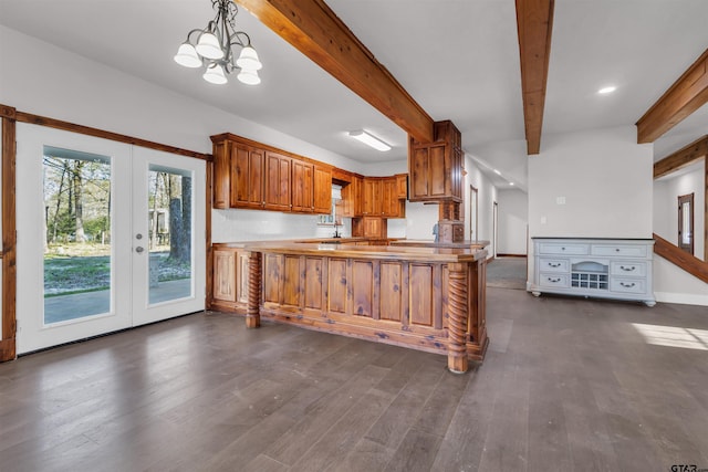 kitchen with dark wood-style floors, a chandelier, brown cabinetry, and beam ceiling