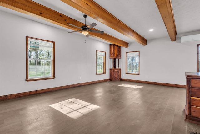 unfurnished living room with baseboards, wood finished floors, a ceiling fan, beam ceiling, and a wall unit AC