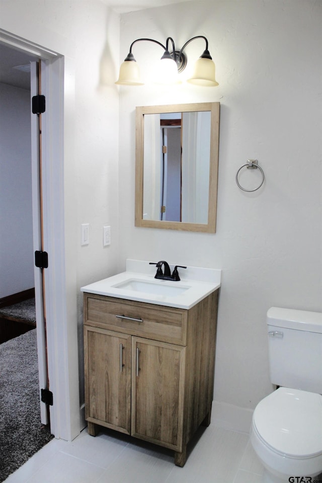 bathroom with vanity, tile patterned floors, and toilet