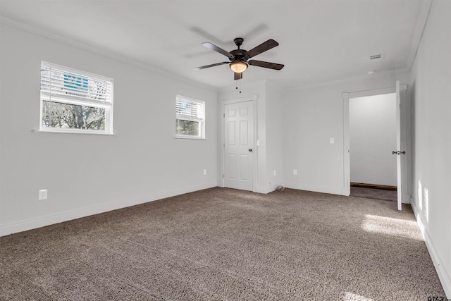 unfurnished bedroom with ornamental molding, carpet, baseboards, and ceiling fan