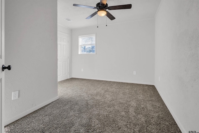 spare room featuring crown molding, carpet flooring, a textured wall, visible vents, and ceiling fan