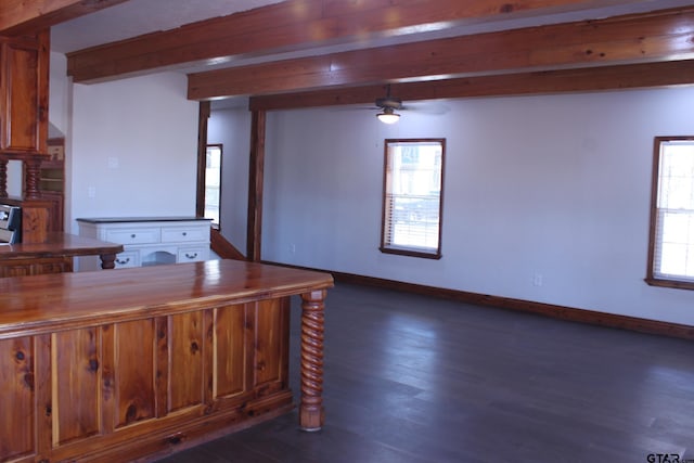 kitchen with dark wood-type flooring, ceiling fan, and beam ceiling