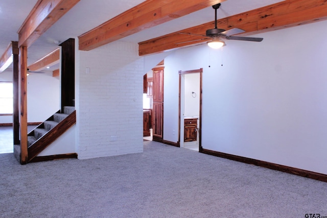 interior space featuring beam ceiling, a wealth of natural light, and ceiling fan