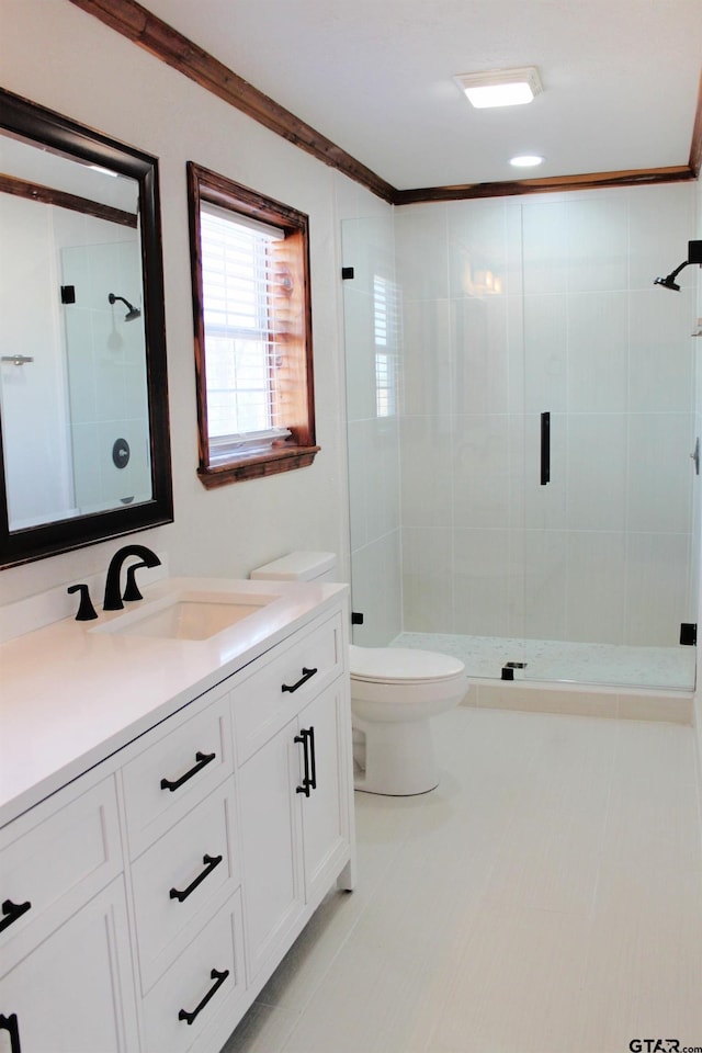 bathroom featuring ornamental molding, a tile shower, vanity, and toilet