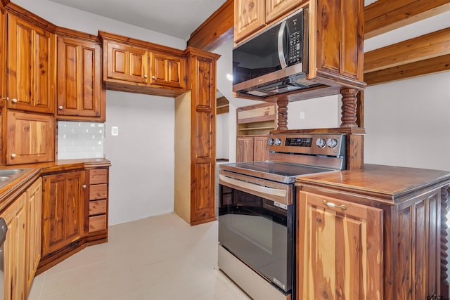 kitchen featuring brown cabinets, tasteful backsplash, and appliances with stainless steel finishes