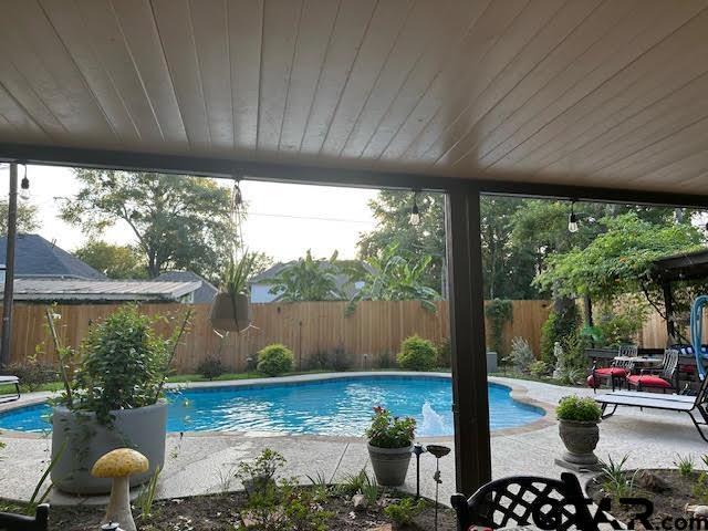 view of swimming pool with a patio