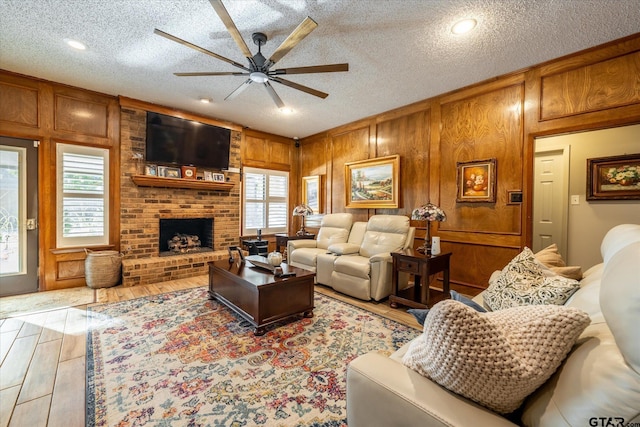 living room featuring a fireplace, a textured ceiling, and a wealth of natural light