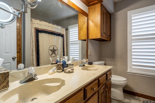 bathroom featuring walk in shower, vanity, and toilet