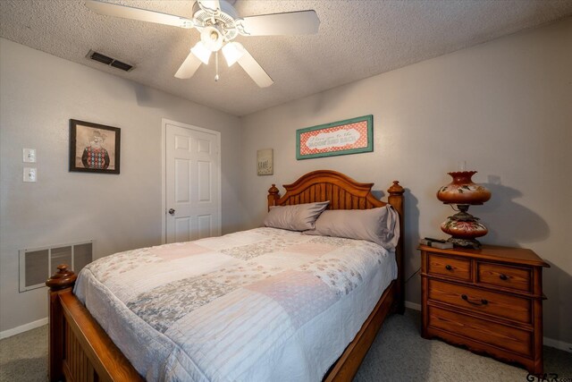 bedroom featuring ceiling fan, a textured ceiling, and carpet flooring