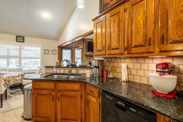 kitchen with a textured ceiling, decorative backsplash, dark stone counters, black dishwasher, and sink