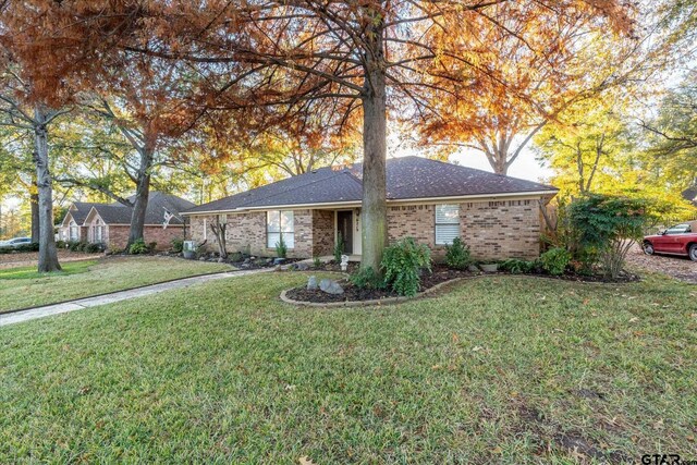 single story home featuring a front lawn