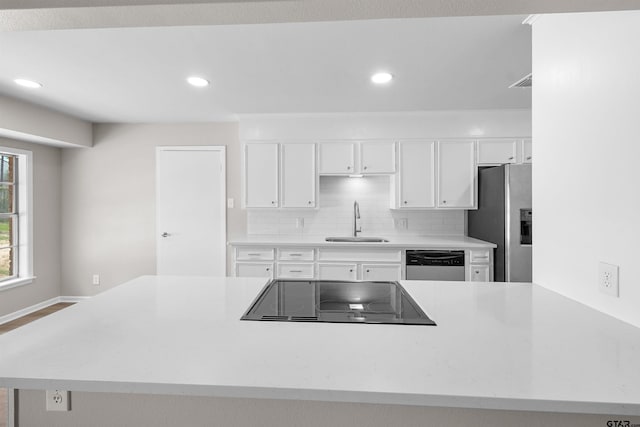 4816 Picadilly Pl, Tyler, TX 75703 - kitchen featuring a sink, stainless steel appliances, white cabinets, recessed lighting, and light countertops