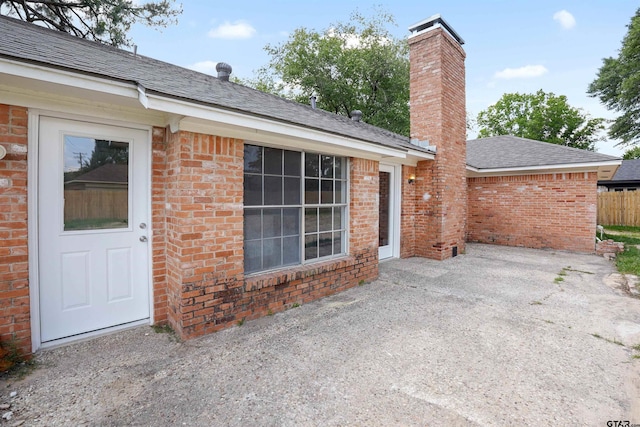 4816 Picadilly Pl, Tyler, TX 75703 - entrance to property featuring brick siding, a patio area, a chimney, and a shingled roof