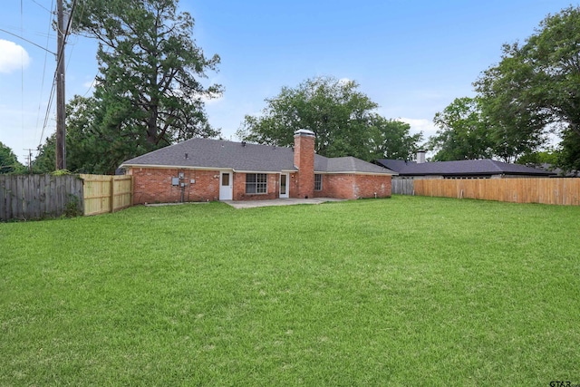 4816 Picadilly Pl, Tyler, TX 75703 - back of property with a patio, a chimney, brick siding, and a shingled roof
