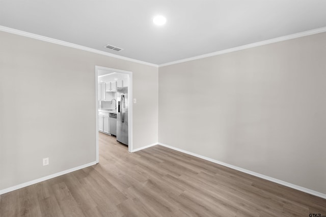 4816 Picadilly Pl, Tyler, TX 75703 - unfurnished room featuring light wood-style floors, ornamental molding, baseboards, and a sink