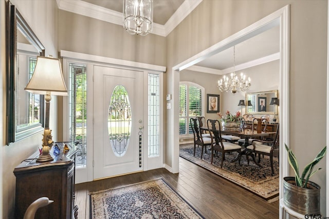 foyer entrance featuring crown molding, a notable chandelier, and dark wood-style floors