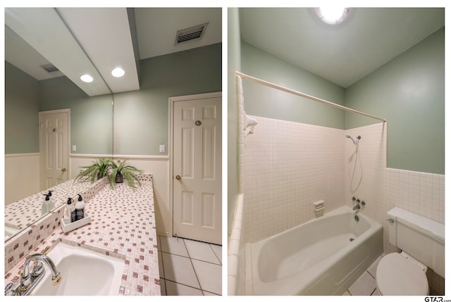 full bathroom with tile patterned floors, toilet, tile walls, tiled shower / bath, and vanity