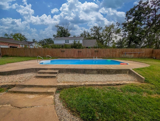 view of pool with a yard and a patio area