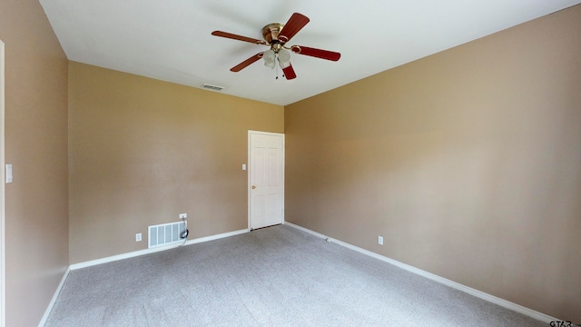 carpeted spare room with ceiling fan