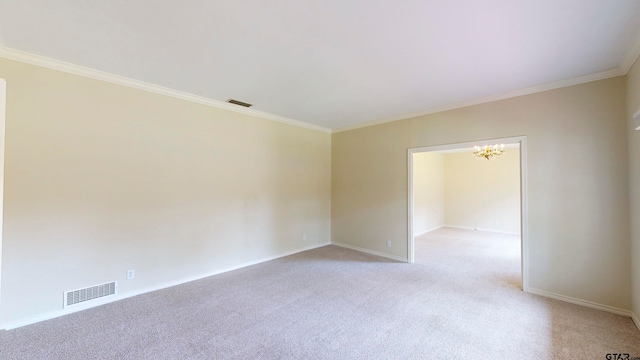 carpeted spare room with a notable chandelier and crown molding