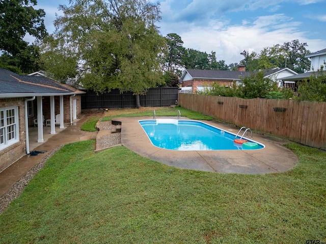 view of pool with a yard and a patio area