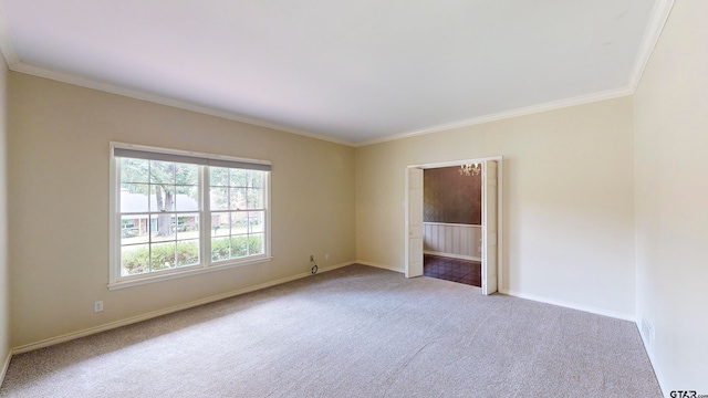 carpeted spare room with crown molding