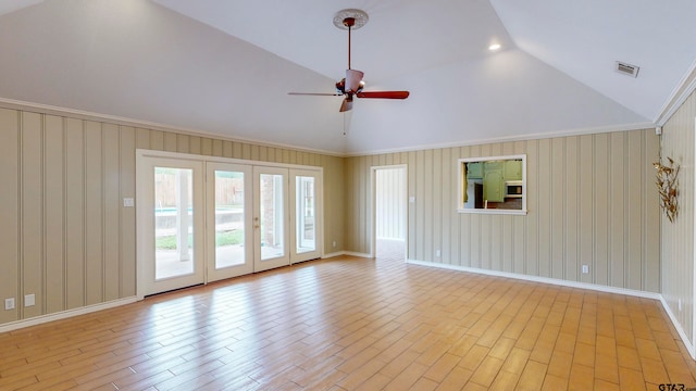 unfurnished living room featuring french doors, crown molding, high vaulted ceiling, ceiling fan, and light hardwood / wood-style flooring