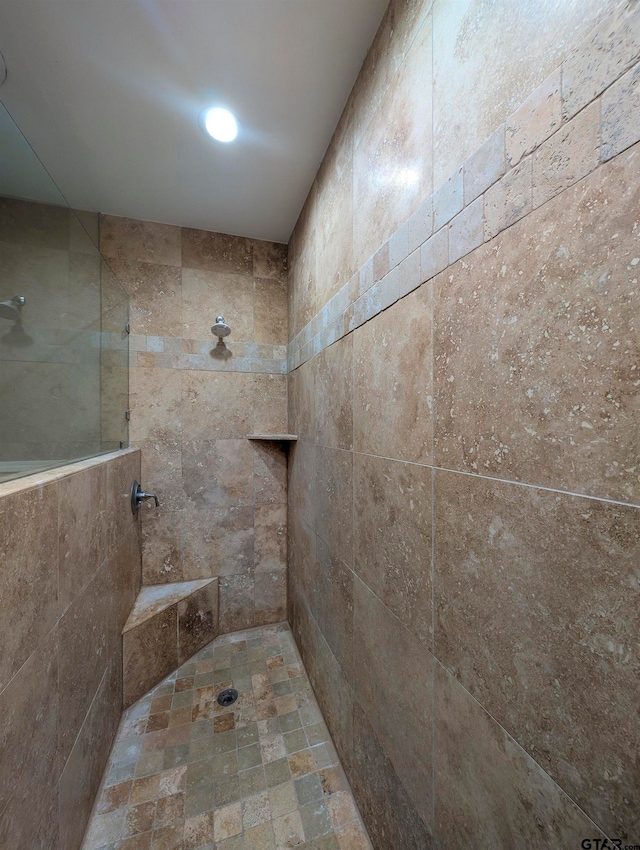 bathroom with tiled shower