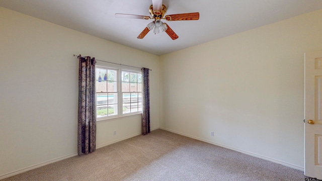 carpeted empty room featuring ceiling fan