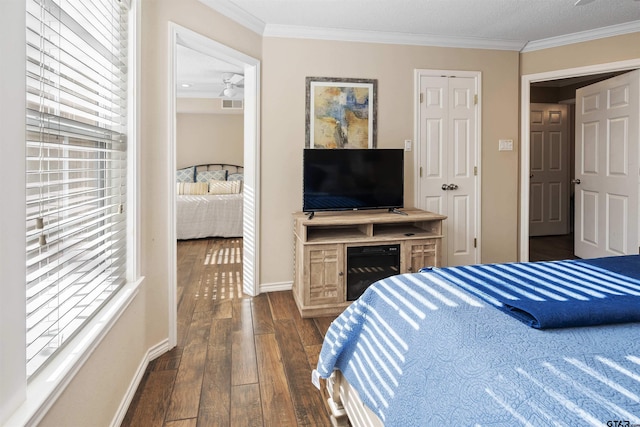 bedroom with crown molding and dark wood-type flooring