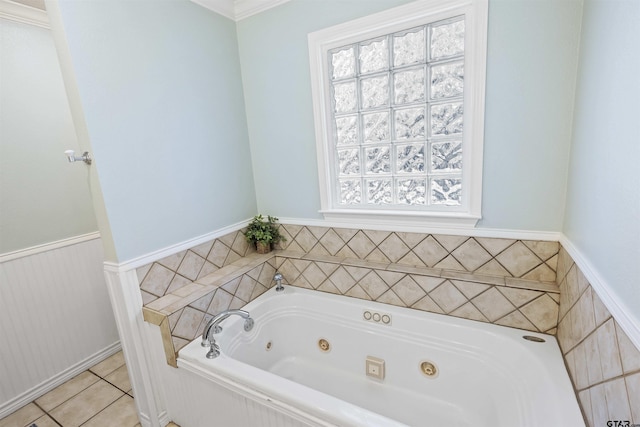 bathroom with tile patterned floors and a bath