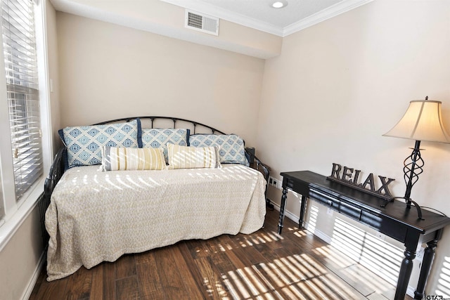 bedroom featuring hardwood / wood-style flooring and crown molding