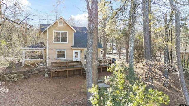 rear view of property with a gazebo and a deck