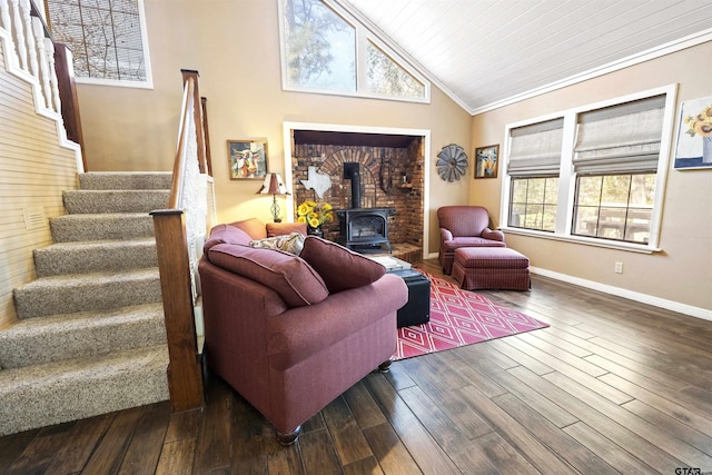 living room featuring hardwood / wood-style floors, vaulted ceiling, wooden ceiling, and a wood stove