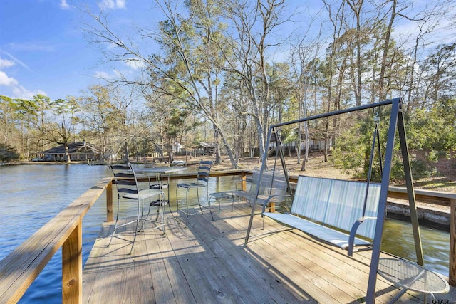 dock area with a water view and exterior bar