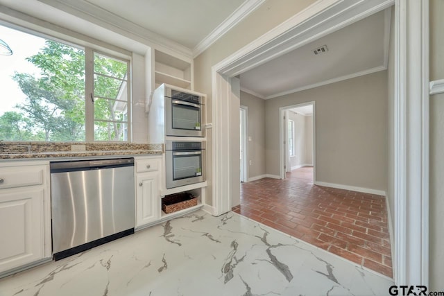 kitchen featuring white cabinets, crown molding, light stone countertops, and stainless steel appliances