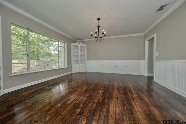 unfurnished dining area featuring ornamental molding, dark hardwood / wood-style floors, and an inviting chandelier