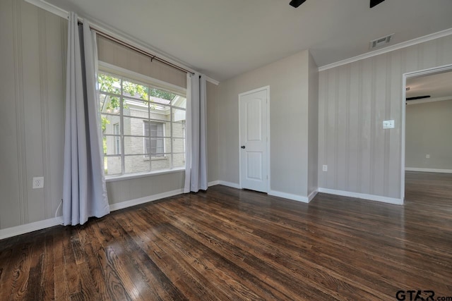 spare room featuring ceiling fan, dark hardwood / wood-style flooring, and crown molding