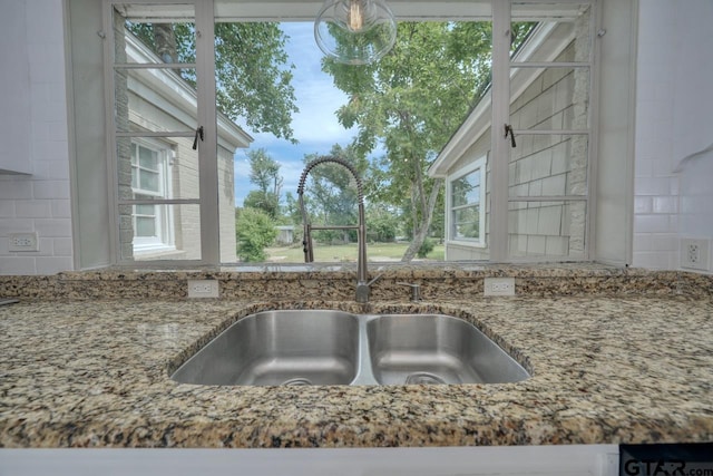 interior details featuring decorative backsplash and sink