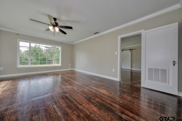 unfurnished room with a barn door, crown molding, ceiling fan, and dark wood-type flooring