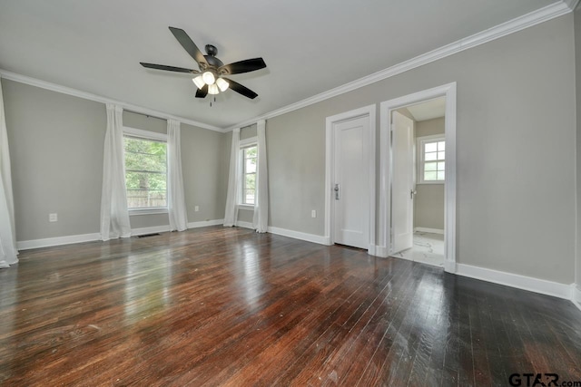 empty room featuring ceiling fan, crown molding, and dark wood-type flooring