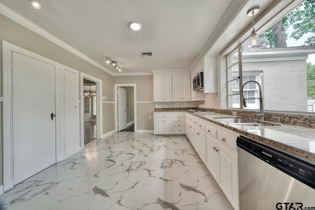 kitchen featuring white cabinets, appliances with stainless steel finishes, light stone countertops, and sink