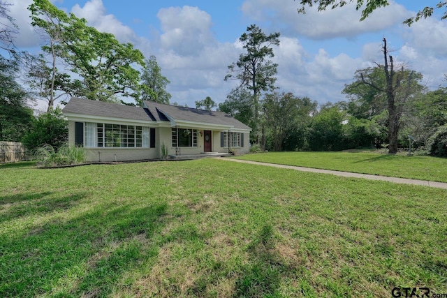 ranch-style home featuring a front yard