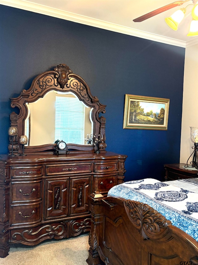 carpeted bedroom with ceiling fan and crown molding