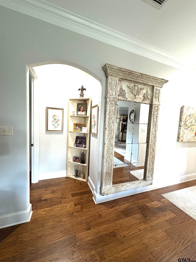 hall featuring ornamental molding and dark hardwood / wood-style floors